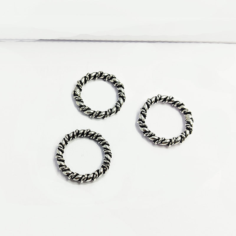 Artisan twisted link silver overlay over copper band ring with textured finish handcrafted in India