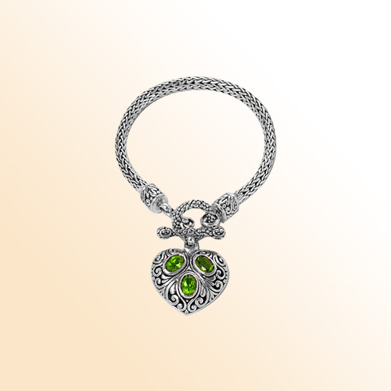 Sterling Silver Woven Bracelet With Ornate Heart Pendant Featuring Peridot Quartz