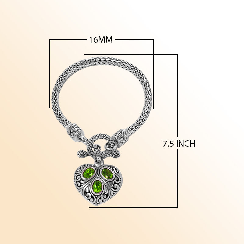 Sterling Silver Woven Bracelet With Ornate Heart Pendant Featuring Peridot Quartz