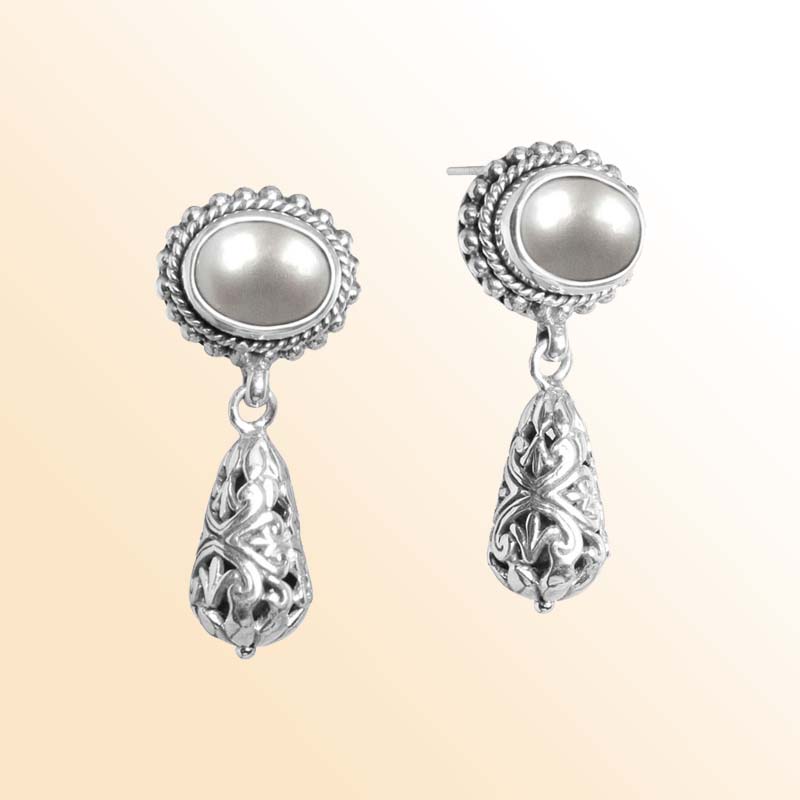 Handcrafted sterling silver earrings with glowing Mabe Pearl tops and ornate Bali filigree teardrops.