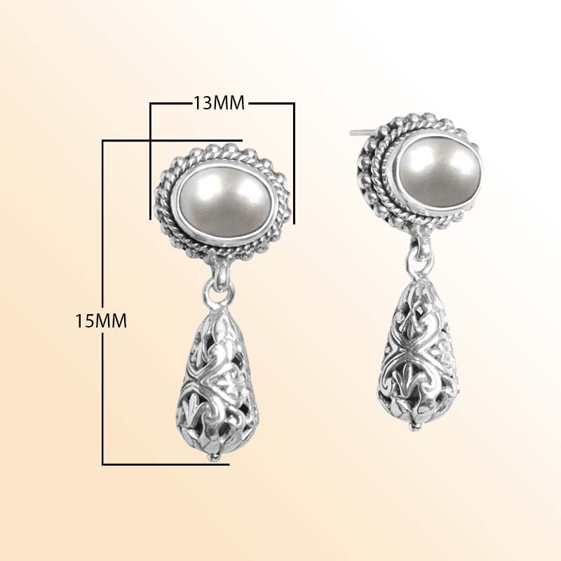 Handcrafted sterling silver earrings with glowing Mabe Pearl tops and ornate Bali filigree teardrops.