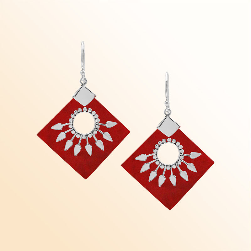 Handcrafted sterling silver earrings with Red Coral diamond shapes and silver sunburst design.