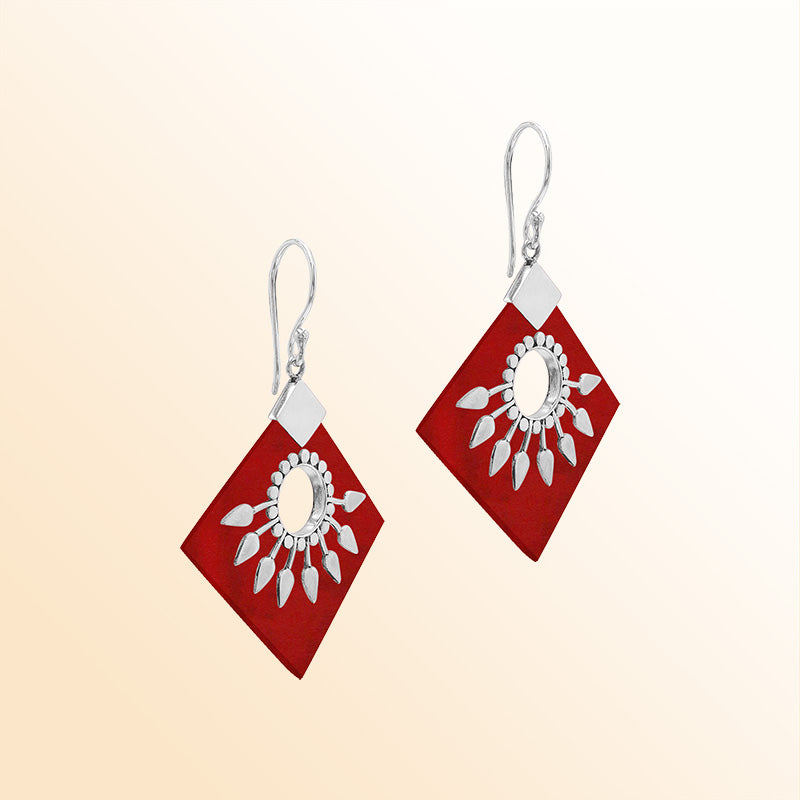 Handcrafted sterling silver earrings with Red Coral diamond shapes and silver sunburst design.