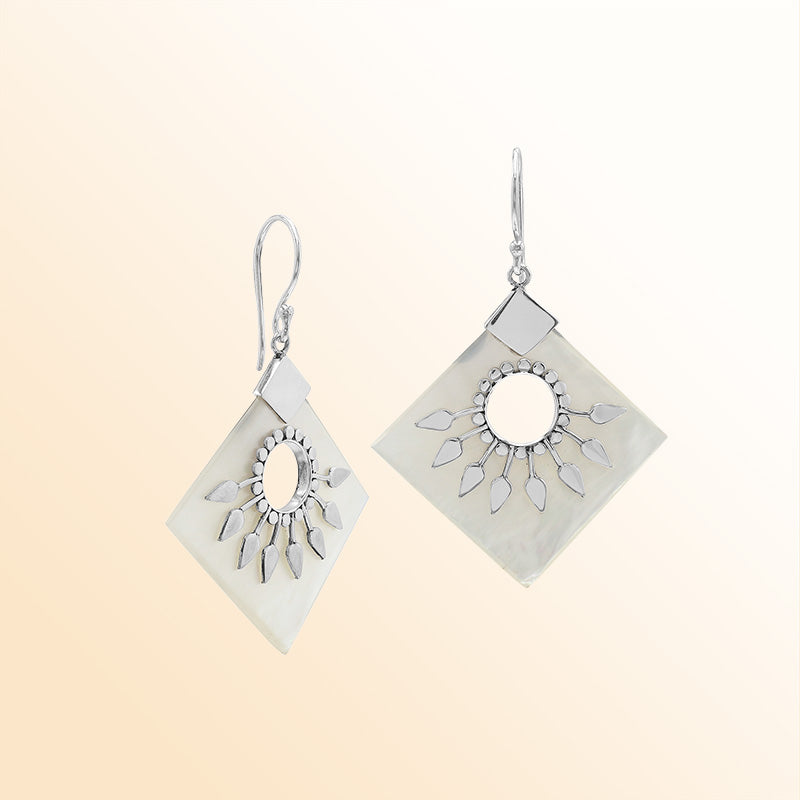 Handcrafted sterling silver earrings with Mother Of Pearl diamond shapes and silver sunburst detailing.