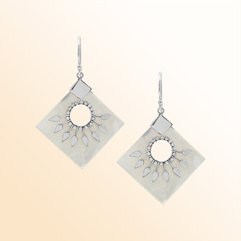 Handcrafted sterling silver earrings with Mother Of Pearl diamond shapes and silver sunburst detailing.