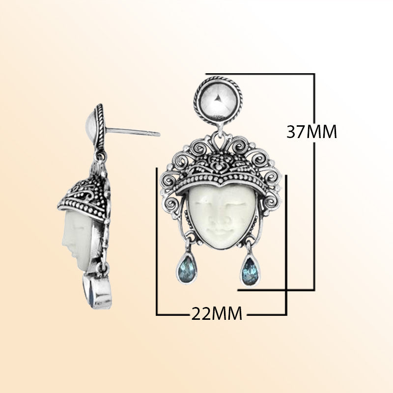 Handcrafted Sterling Silver Earrings With Carved Bone Face And Blue Topaz Quartz Teardrop Design