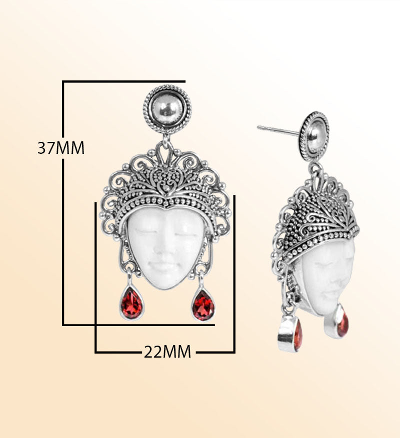 Handcrafted Sterling Silver Earrings With Carved Bone Face And Garnet Quartz Teardrop Design