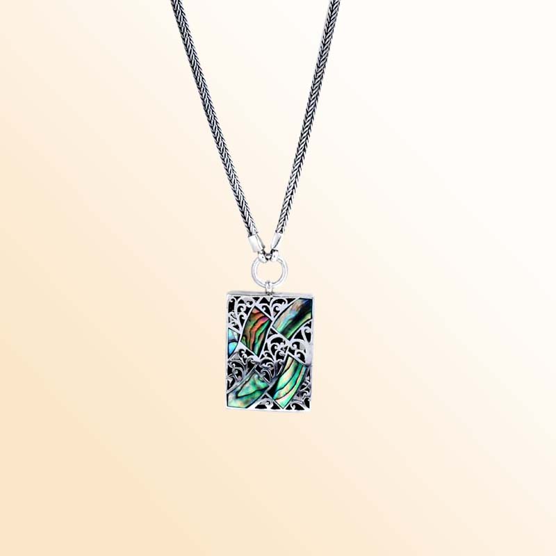 Handcrafted Sterling Silver Bali Abalone Shell Pendant Necklace With Reflective Finish And Scrollwork Detail.