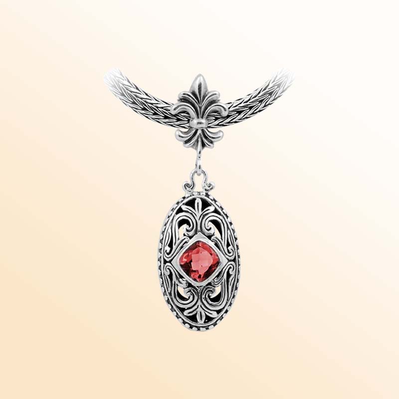 Handcrafted Sterling Silver Oval Pendant With Garnet Quartz And Fleur-De-Lis Bail Detailing.