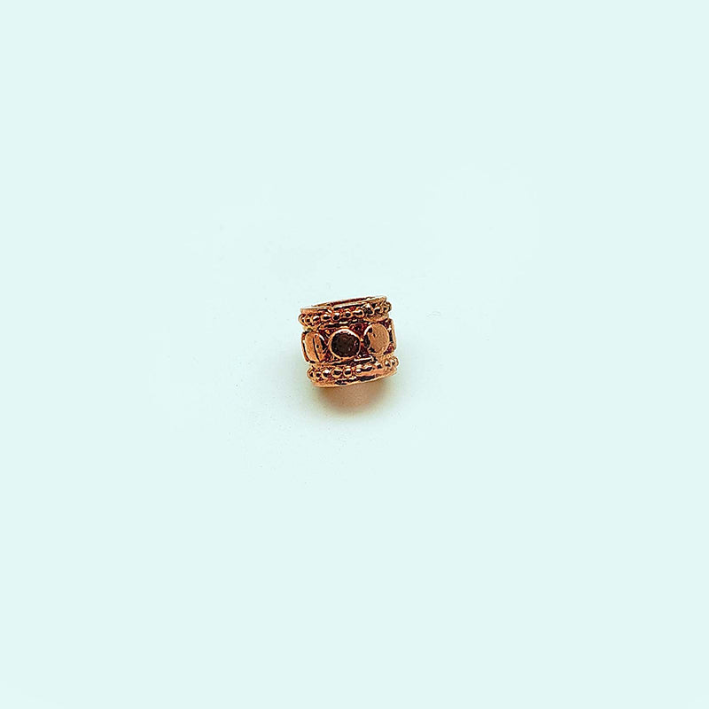 Decorative barrel spacer bead with dome detailing in rose gold overlay over copper, handcrafted in India