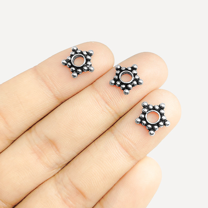 Silver overlay over copper open star spacer beads handcrafted in India with star bubble design and polished finish.