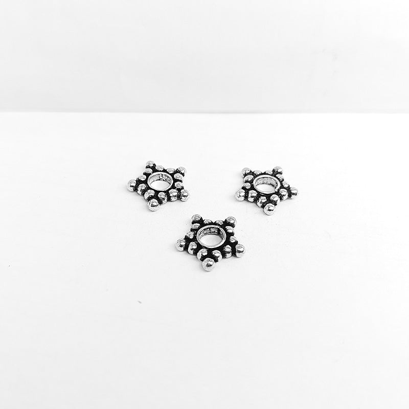 Silver overlay over copper open star spacer beads handcrafted in India with star bubble design and polished finish.