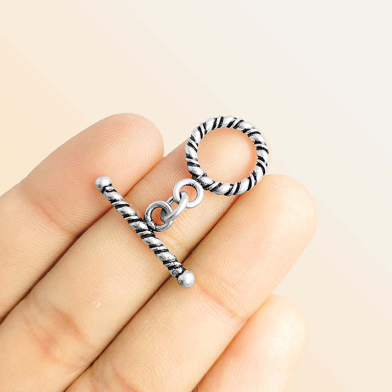Decorative Silver Overlay toggle clasp with twisted rope bar and circular loop, oxidized finish, artisan jewelry fastener for bracelets and necklaces.