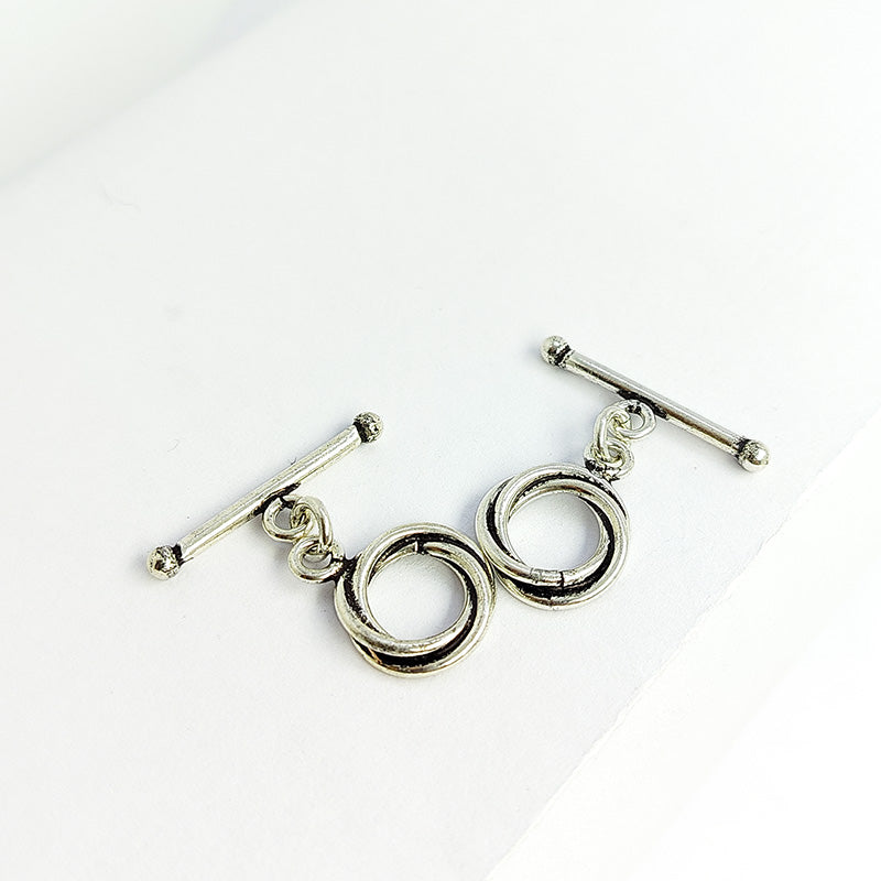 Handcrafted antique Silver Overlay toggle clasp with interlocking double rings and straight bar, Bali jewelry closure for necklaces and bracelets.