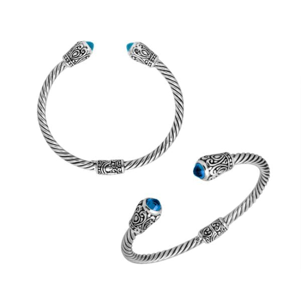 Handmade silver bangle with blue topaz quartz ends and Balinese carved design