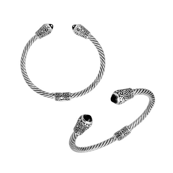 Handmade silver bangle with black onyx ends and Balinese carved design