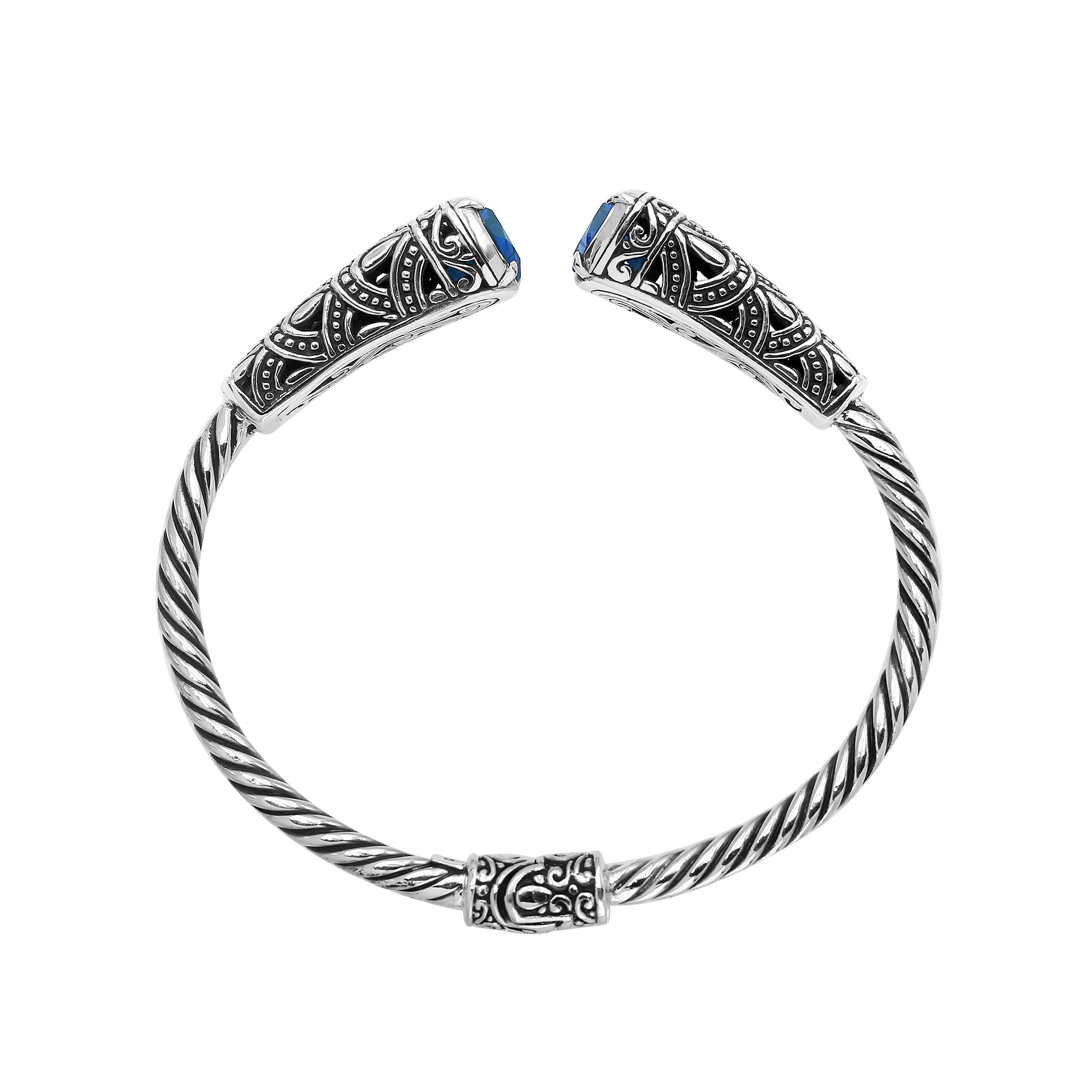 Elegant sterling silver open bangle with blue topaz quartz accents and Balinese detailing