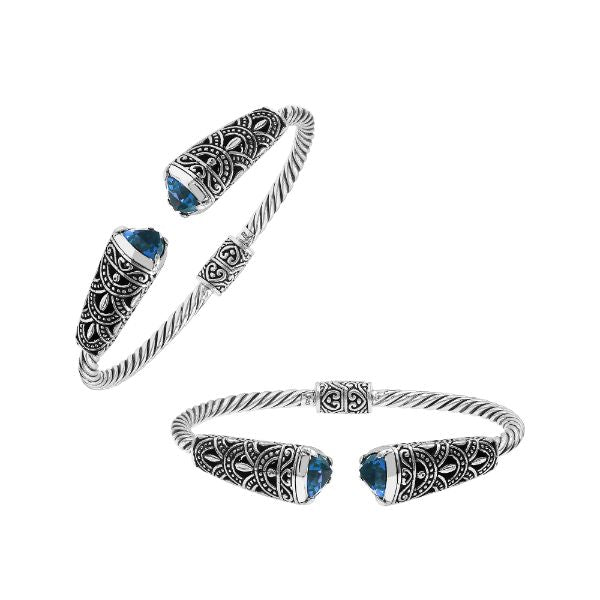 Elegant sterling silver open bangle with blue topaz quartz accents and Balinese detailing