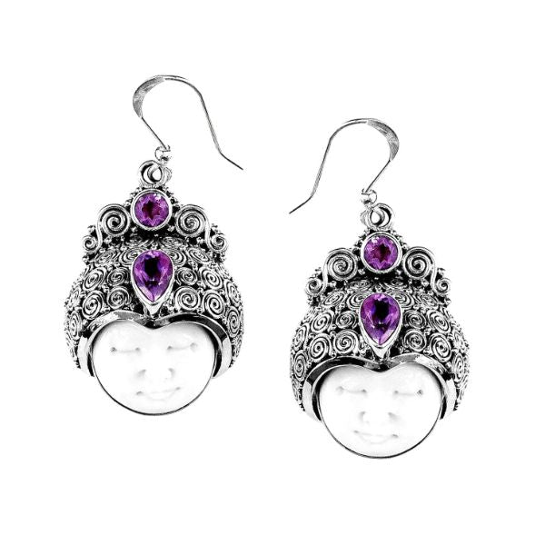 Handcrafted sterling silver earrings with carved bone faces, ornate Balinese scrollwork, and faceted amethyst Quartz, artisan Bali jewelry for unique style.