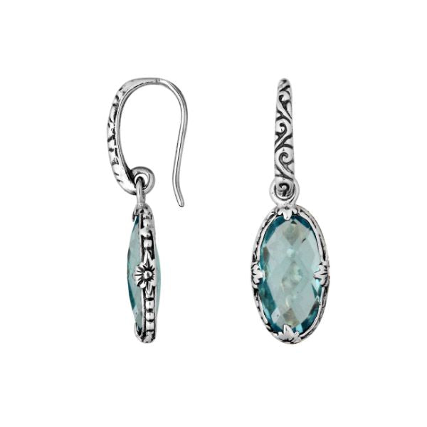 A stunning pair of 925 sterling silver earrings featuring oval Blue Topaz Quartz stones with Balinese floral detailing and earwire hooks for a modern elegant look.