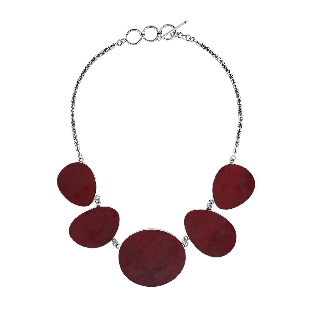 Handcrafted silver necklace with oval red coral links in elegant ocean-inspired design.