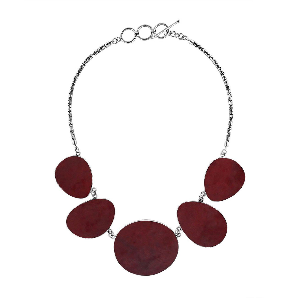 Handcrafted silver necklace with oval red coral links in elegant ocean-inspired design.