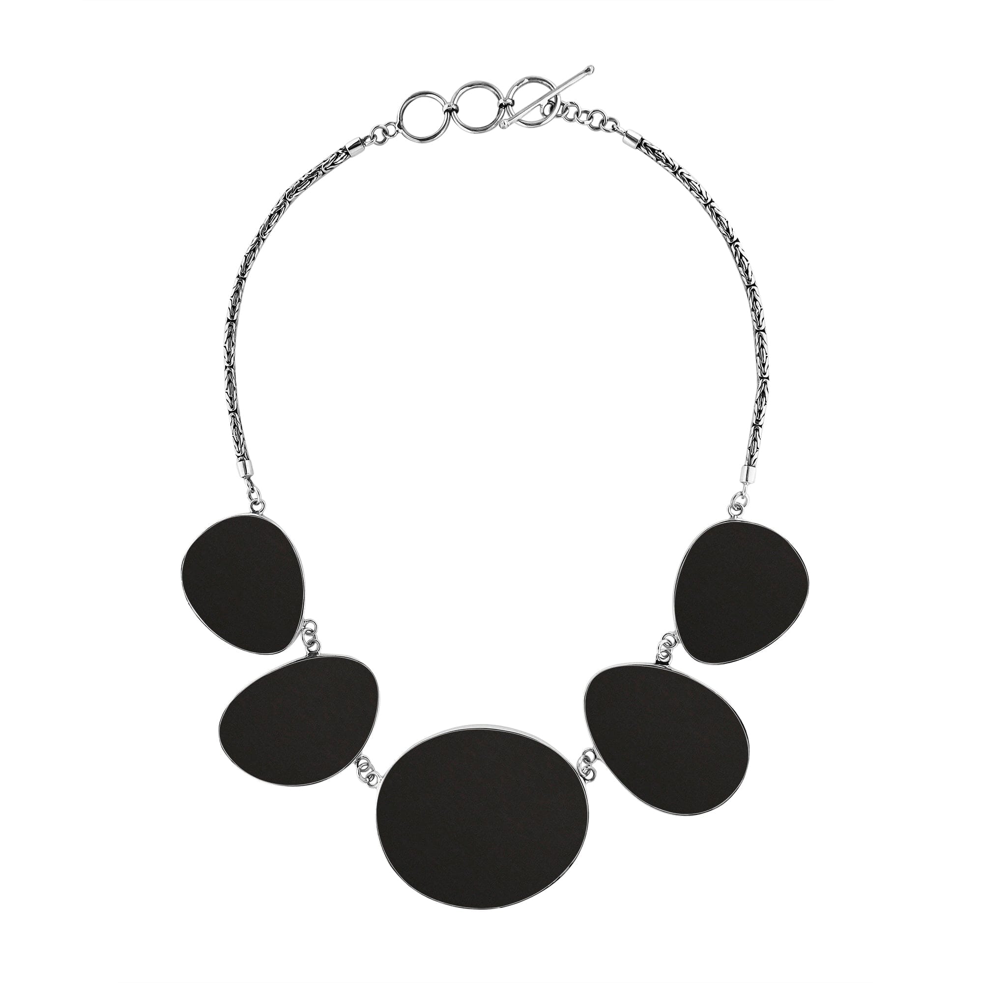 Handcrafted silver necklace with oval black shell links in bold artisan design.