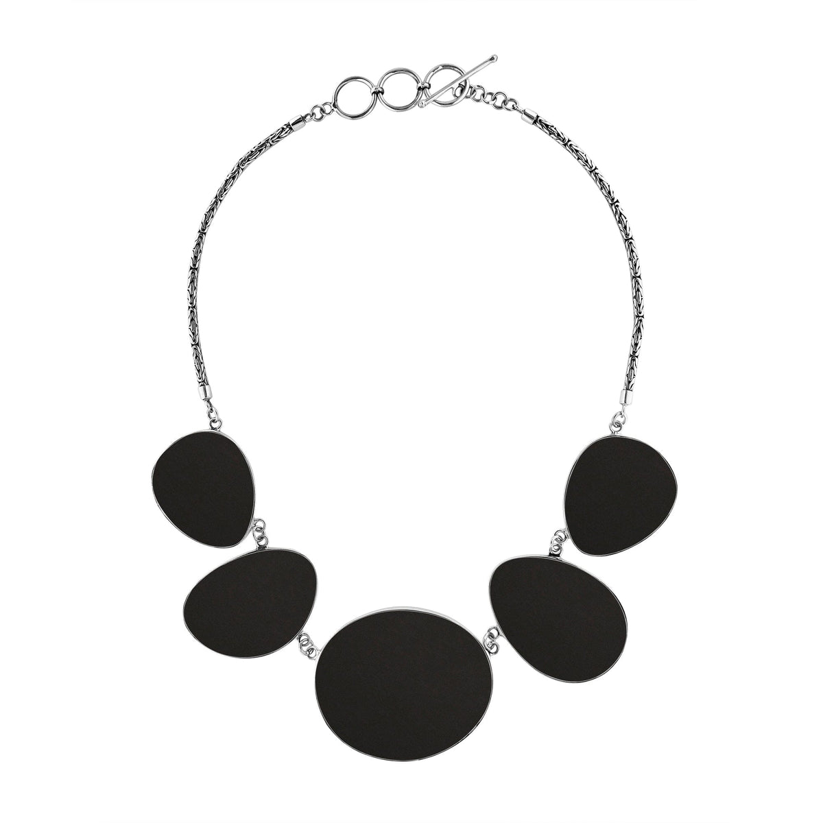 Handcrafted silver necklace with oval black shell links in bold artisan design.