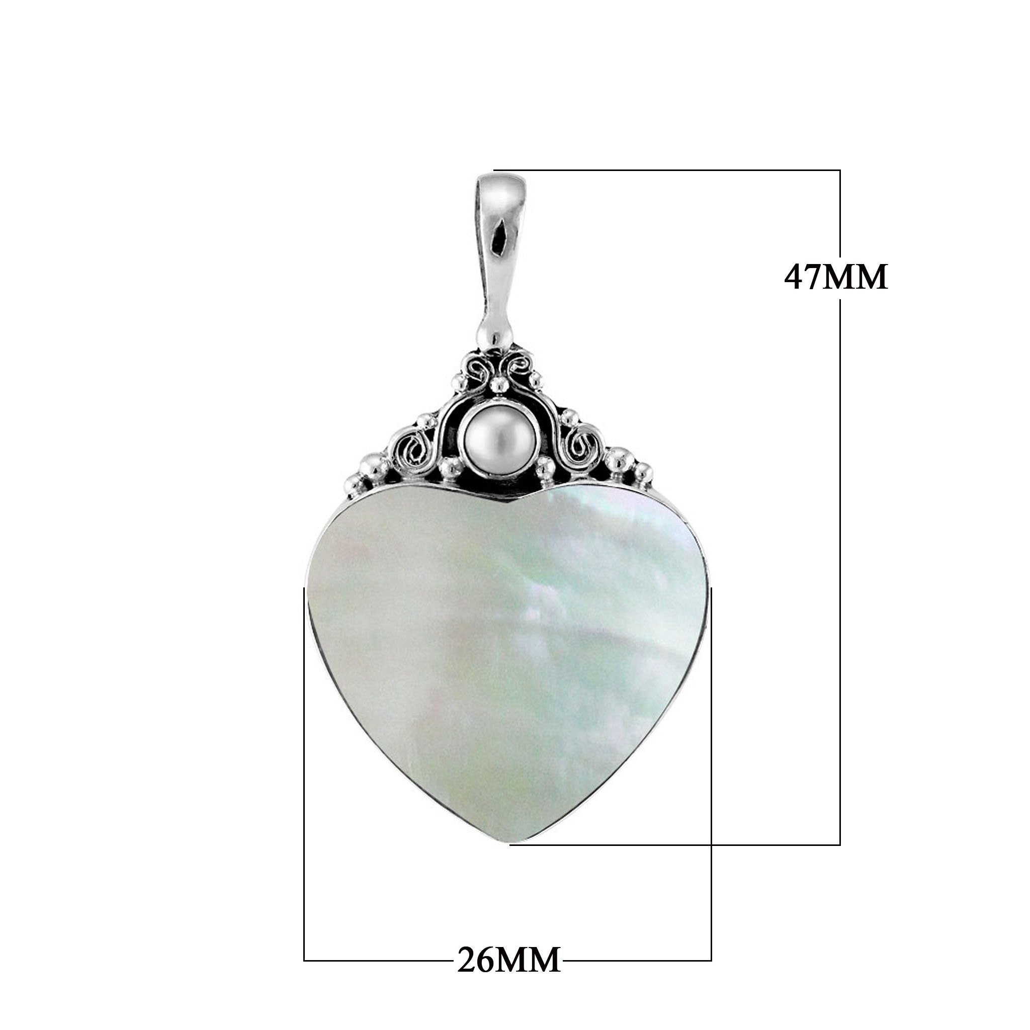 Handcrafted sterling silver heart pendant with luminous Mother of Pearl centerpiece and delicate Balinese scrollwork, artisan jewelry for timeless elegance.
