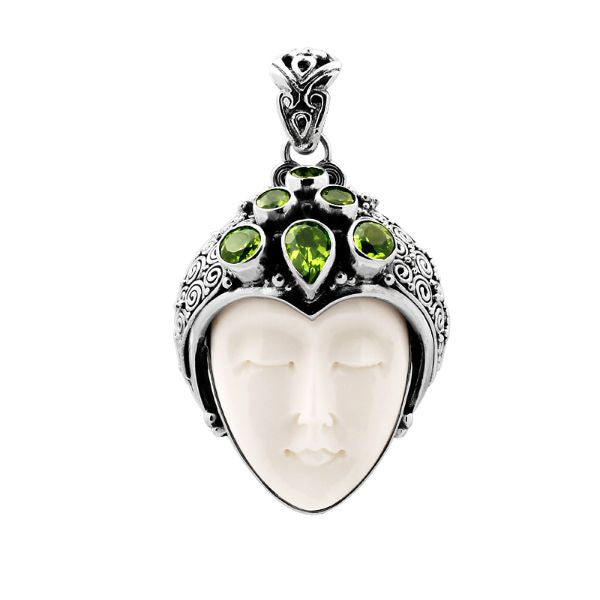 Sterling silver pendant with hand-carved bone face and sparkling peridot gemstones, unique Bali artisan jewelry.