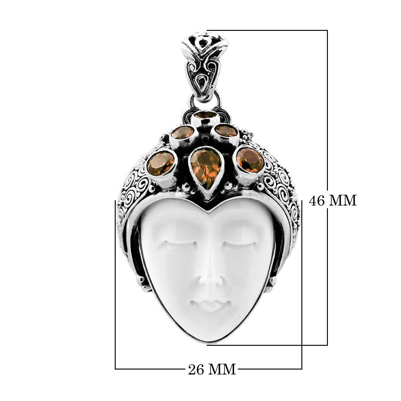 Handcrafted sterling silver pendant featuring a serene goddess face carved from bone with sparkling citrine gemstones, Balinese artisan jewelry for women.