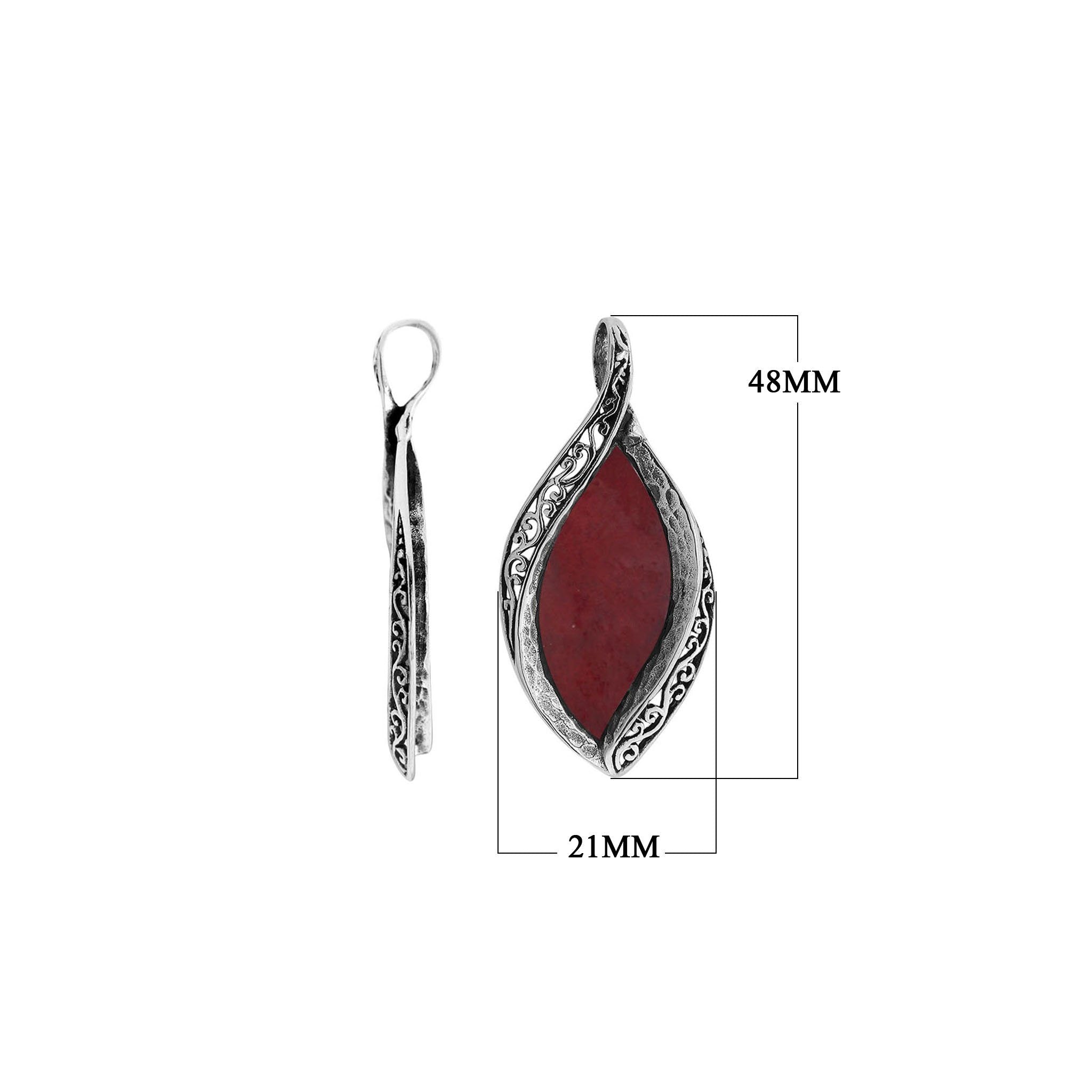 Sterling silver marquise pendant with vibrant red coral inlay and detailed Balinese carving, handcrafted in Bali.