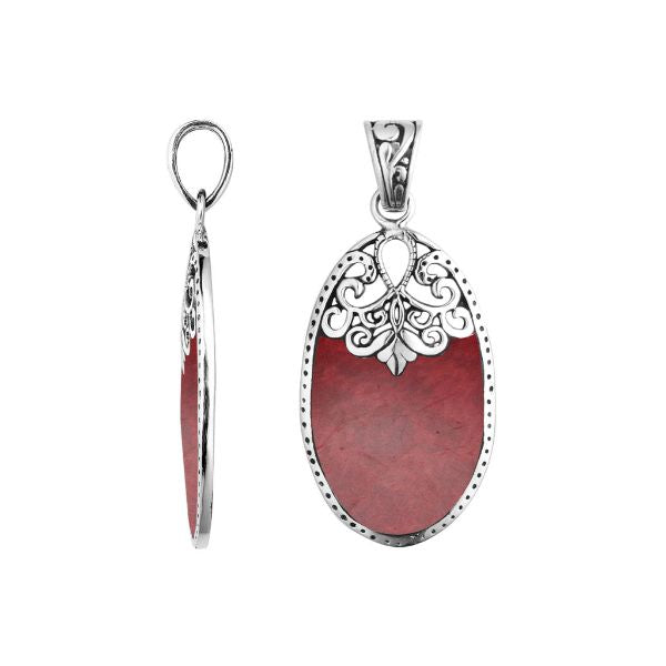 Sterling silver oval pendant with vibrant red coral inlay and delicate Balinese filigree design, handcrafted in Bali.