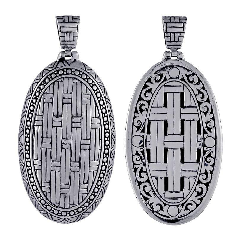 Artisan sterling silver oval pendant with woven texture and detailed borders.
