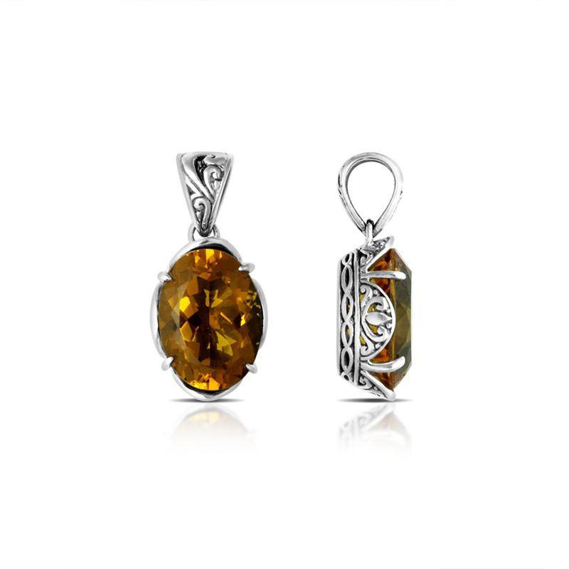 Sterling silver pendant with golden oval-cut citrine quartz, Balinese handcrafted with carved sides and oxidized finish.
