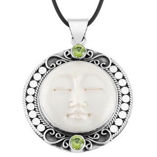 Retail Peridot Quartz pendant with carved bone face handmade in sterling silver with Balinese detailing.