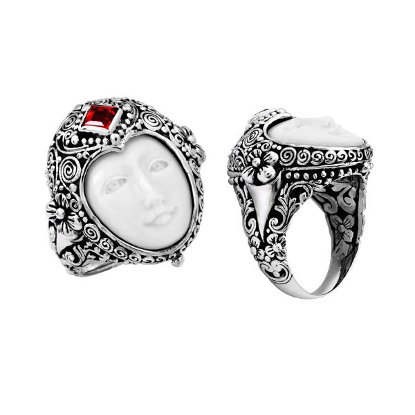 Handcrafted sterling silver ring with carved Bone Face, Garnet Quartz, and detailed Balinese floral design, unique artisan statement jewelry.