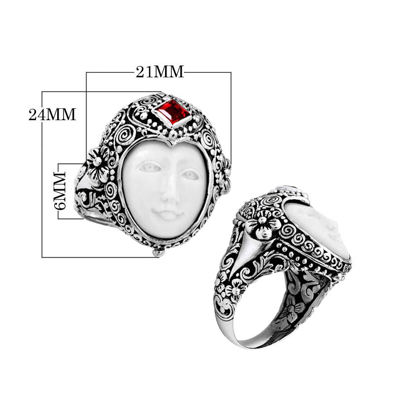Handcrafted sterling silver ring with carved Bone Face, Garnet Quartz, and detailed Balinese floral design, unique artisan statement jewelry.