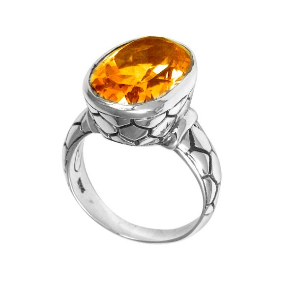 Handcrafted sterling silver ring with oval Citrine Quartz and artisan carved band, made in Bali.