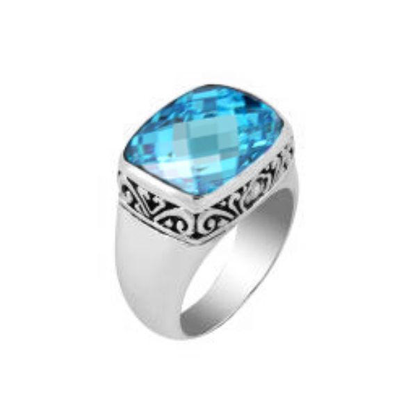 Sterling silver ring with a sparkling cushion-cut blue topaz  Quartz and delicate Balinese scroll details, handcrafted for a bold and elegant look.