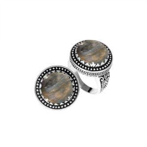 Handcrafted sterling silver Bali ring with Labradorite cabochon and beaded halo design.