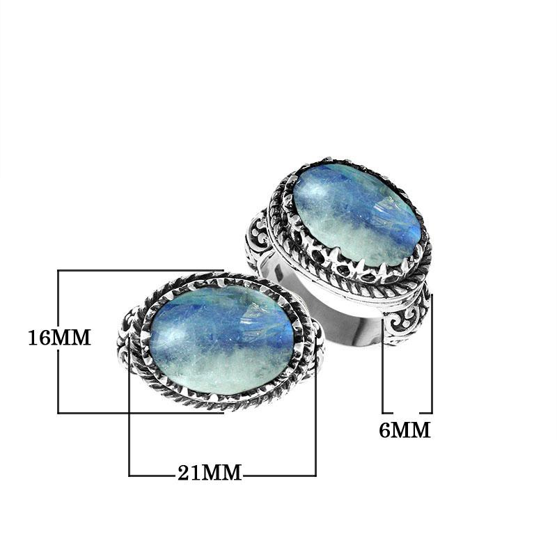Handcrafted Bali sterling silver ring with oval Rainbow Moonstone, Blue Quartz, and ornate scroll design for retail customers.