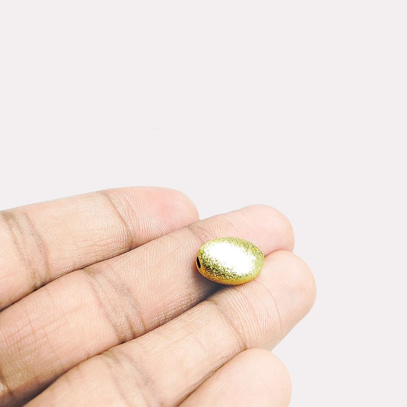 Smooth oval barrel jewelry bead with 18K gold overlay over copper handcrafted in India